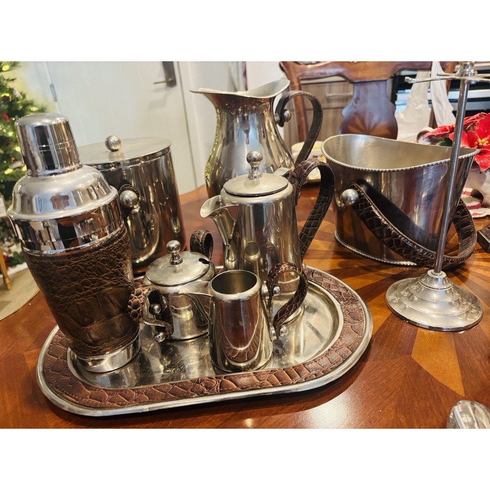Silver-plated beverage service set with embossed leather accents.